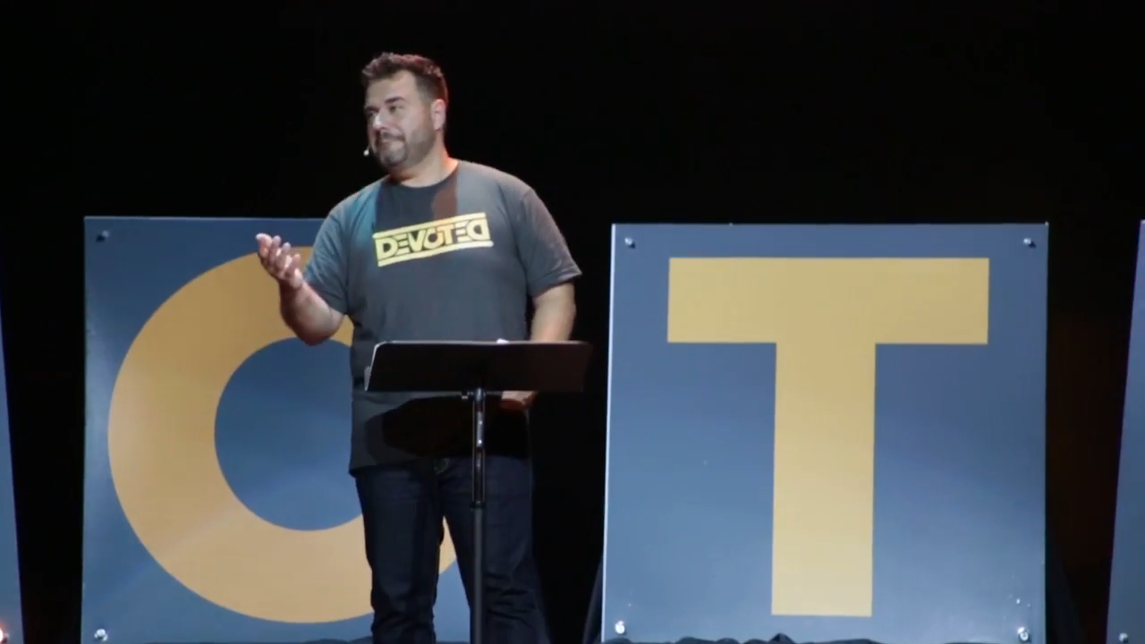 Lead Pastor Dave Dummitt speaking about 242’s Devoted initiative while wearing his Devoted shirt printed by Ann Arbor Tees!